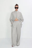 Relaxed-fit gray blouse from Malva Florea, made of lightweight fabric, shown on a hanger with soft draping.