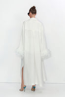 Ivory cape-style trench coat by Malva Florea featuring a stylish, flowing design and classic button details.