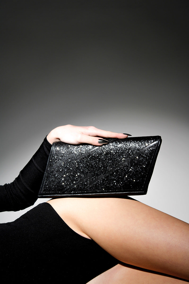 Black glitter Terry de Havilland Mia clutch bag with sleek, compact design and metallic finish, ideal for evening accessories.