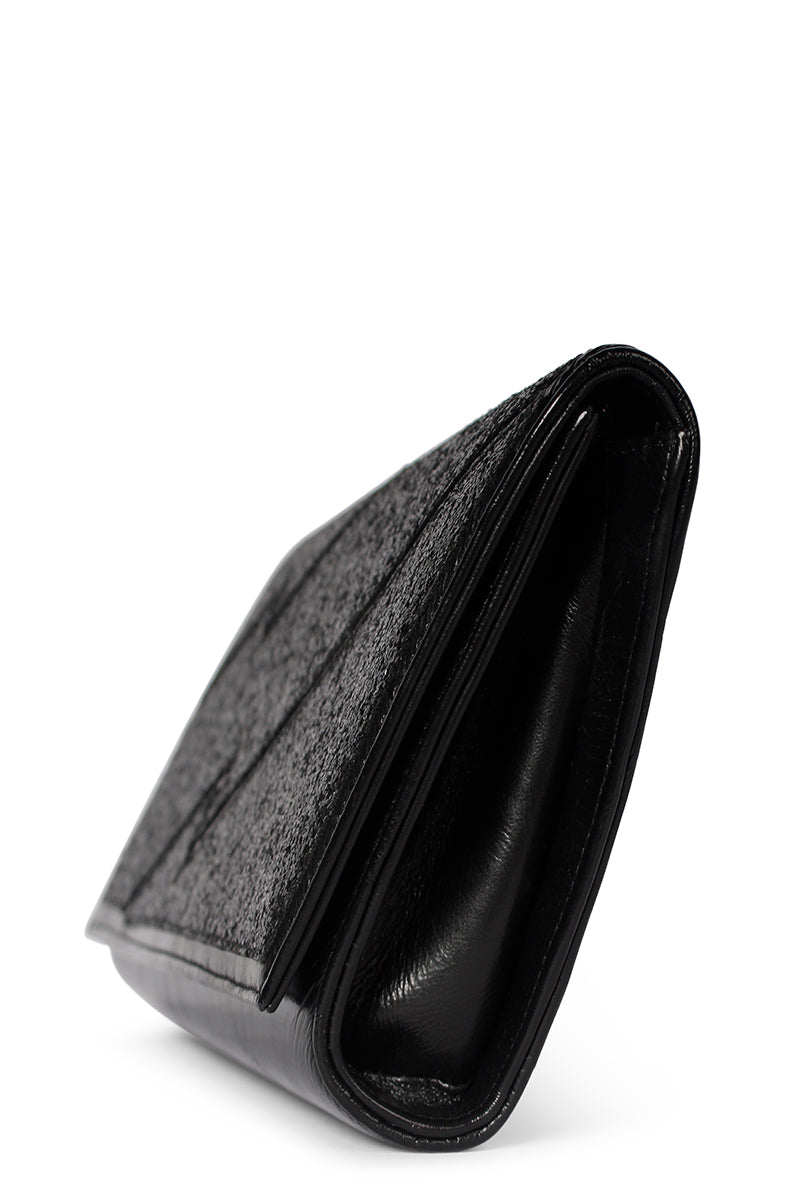Black glitter clutch bag by Terry de Havilland, featuring a sleek, compact design with a stylish, shimmering finish.