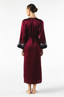 NK IMODE Roxy long silk robe in Bordeaux, featuring luxurious fabric and elegant design, shown on a model.