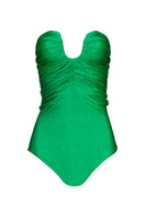 Emerald green Laura Escobar Serrania one-piece swimsuit displayed on a model, showcasing its sleek design and vibrant color.