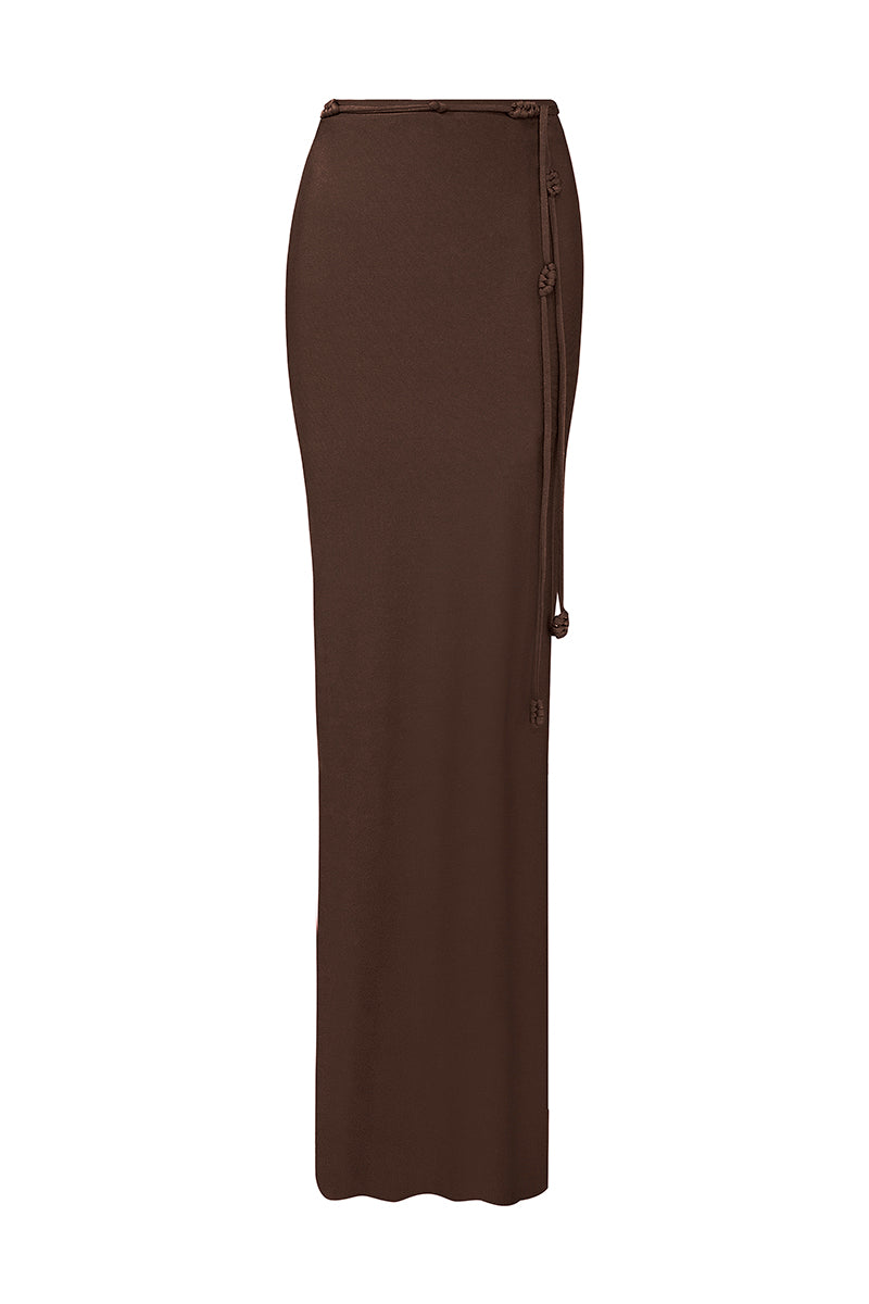 Laura Escobar Pitaya Mocca Maxi Skirt in soft brown fabric, flowing design, displayed on a hanger against a neutral background.