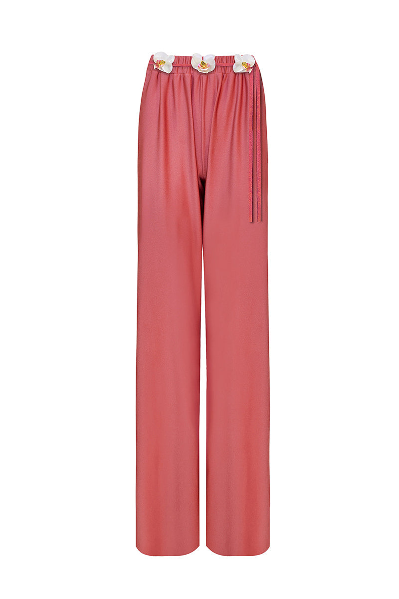 Light coral Flora pants by Laura Escobar, showing relaxed fit, waistband, and soft fabric texture.