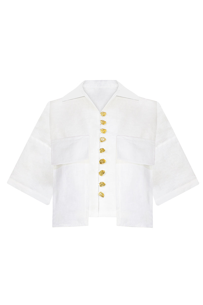 White LINA shirt by LAURA ESCOBAR featuring a classic fit, button-down front, and soft fabric, displayed on a hanger.