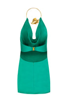 Emerald green Lily mini dress by Laura Escobar displayed on a hanger, showcasing its vibrant color and stylish mini length.