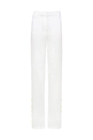 White Laura Escobar Lina pants, tailored women's pants with a sleek fit, shown in a stylish studio setting.