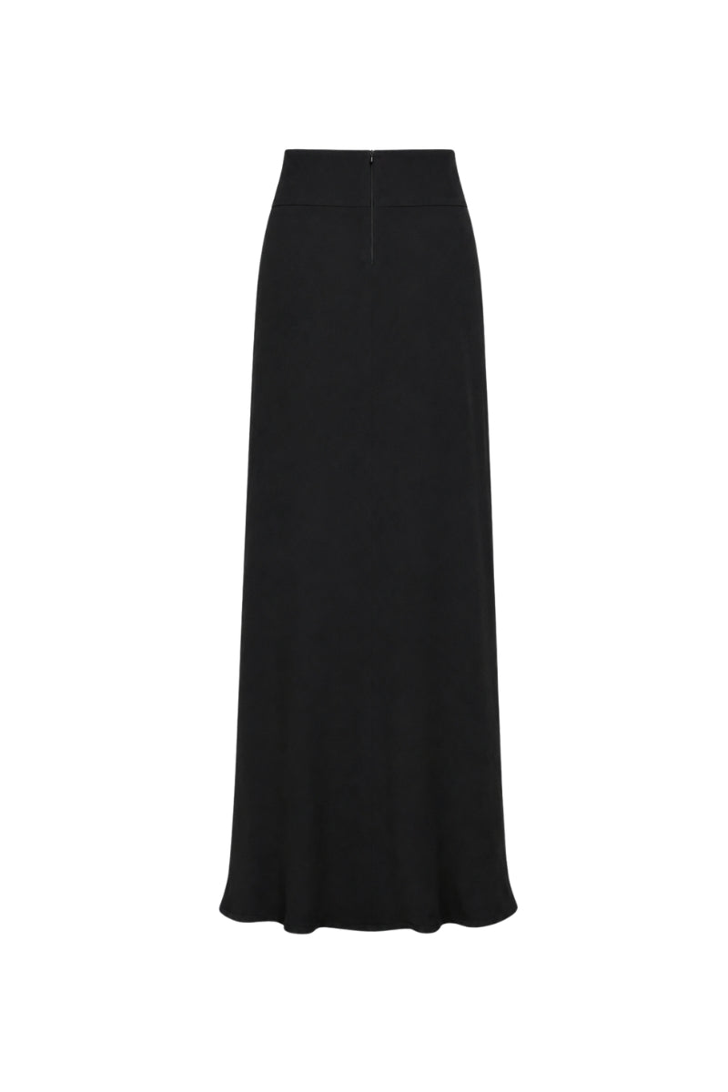 Black Tinta Latina Miel Maxi Skirt displayed on a model, showcasing its flowy fabric and elegant design.