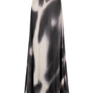 Black printed Tinta Latina Miel maxi skirt with flowing fabric and elastic waistband, displayed on a hanger.