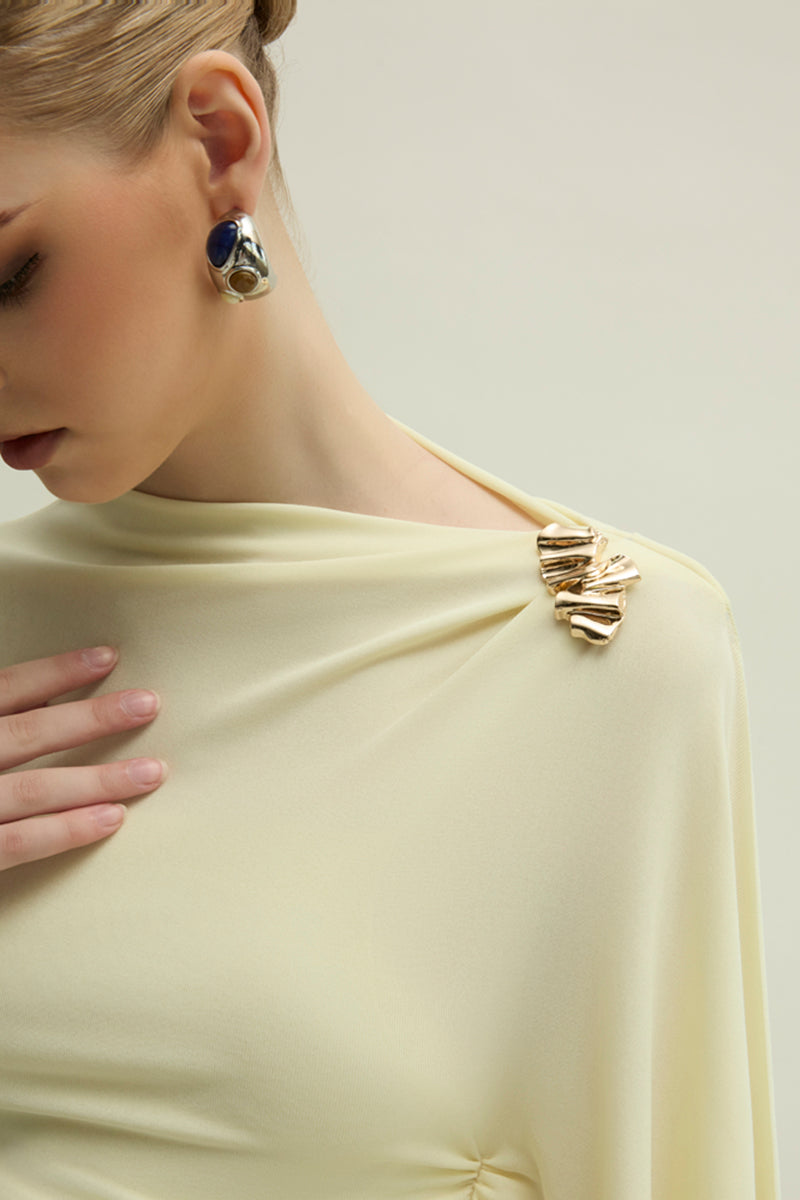 Yellow Minerva gown by Jenny K Tran featuring elegant flowing fabric and intricate detailing on the dress.