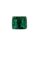 Emerald green mini skirt by Mirel Prentice with hand-crochet sequins, showcasing intricate embellishments and a fitted silhouette.