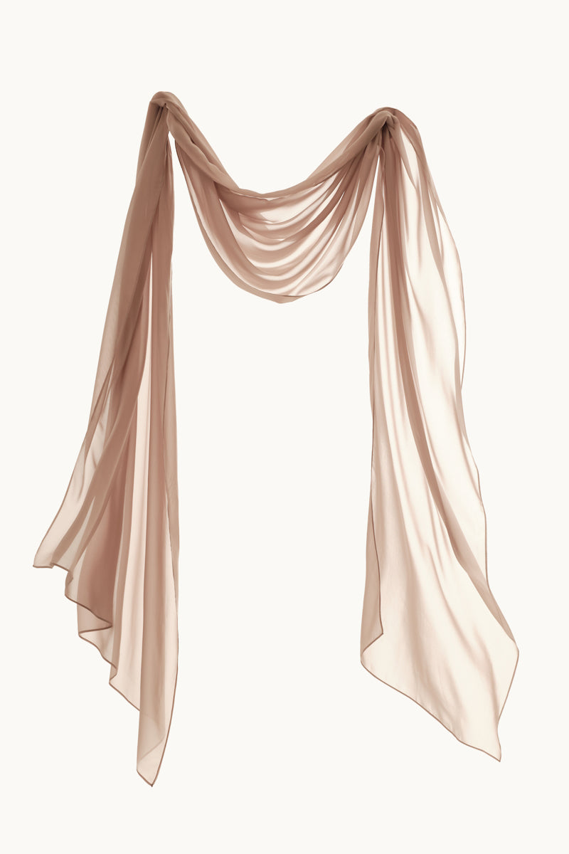 Monetre CULT MIA X Monetree Lueur gown displayed on a hanger, featuring elegant fabric and intricate design details.