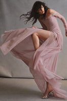 Elegant CULT MIA X Monetre Céline gown displayed on a model, featuring flowing fabric and sophisticated design.