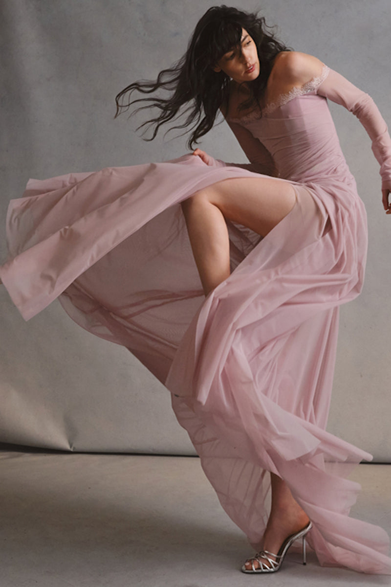 Elegant CULT MIA X Monetre Céline gown displayed on a model, featuring flowing fabric and sophisticated design.