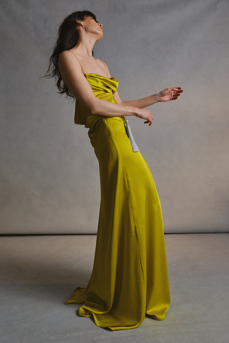 Elegant CULT MIA X MONETRE Viride gown displayed on a hanger, featuring flowing fabric and intricate detailing.