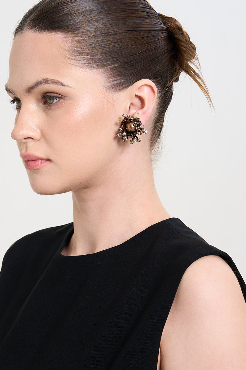 A model wearing gold Lush earrings by Aidan & Ice, showcasing elegant gold earrings with a sleek, polished finish.