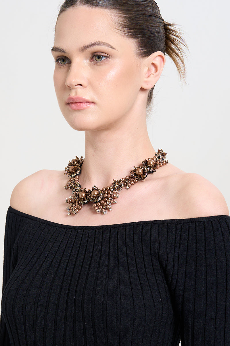 Model wearing the Golden Grace necklace by Aidan & Ice, featuring a delicate gold chain with a subtle pendant.