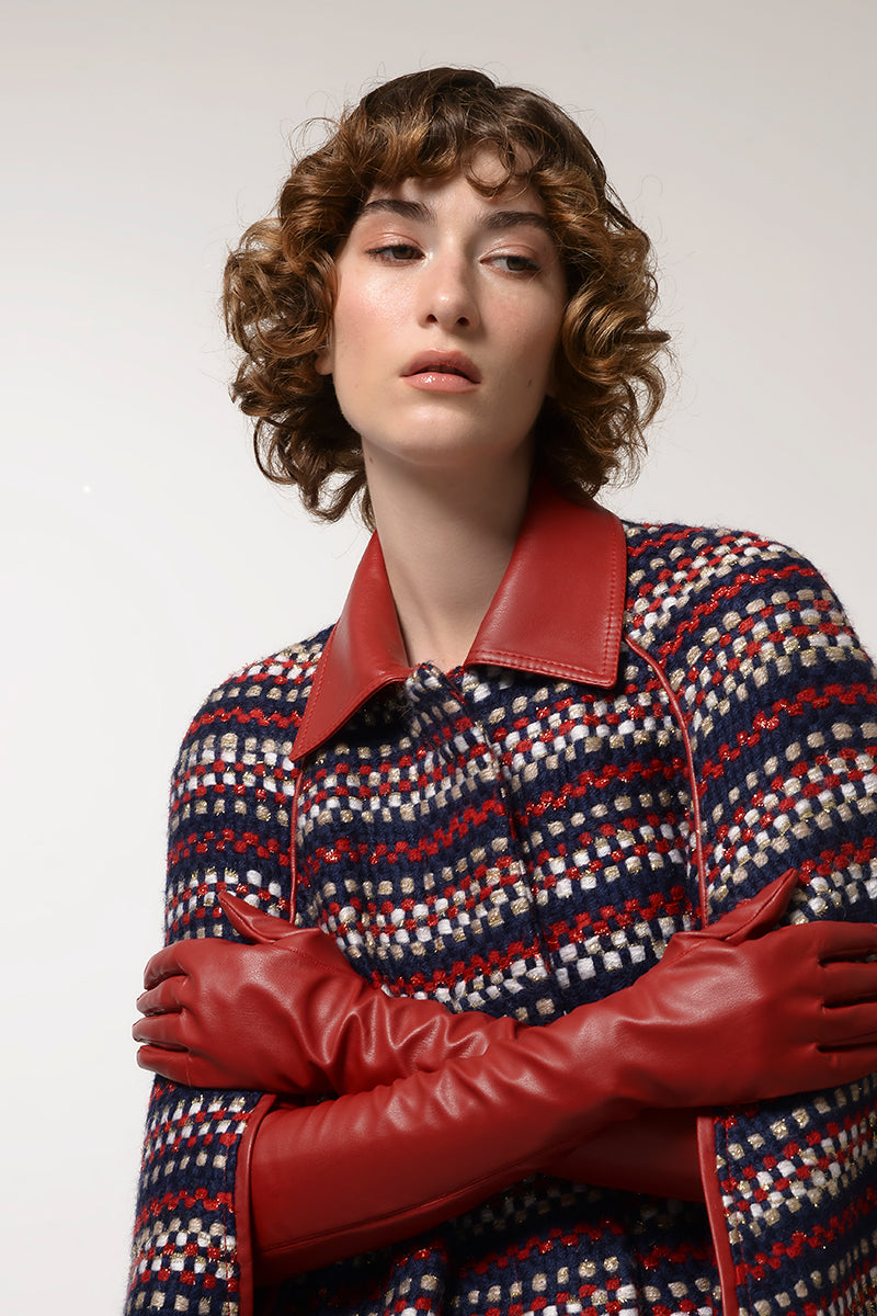 Brushed red wool cape coat by Lalo displayed on a hanger, showcasing its textured fabric and classic design.