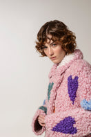 Lalo pink hearts wool coat displayed on a hanger with a soft pink and white heart pattern, stylish winter outerwear for women.