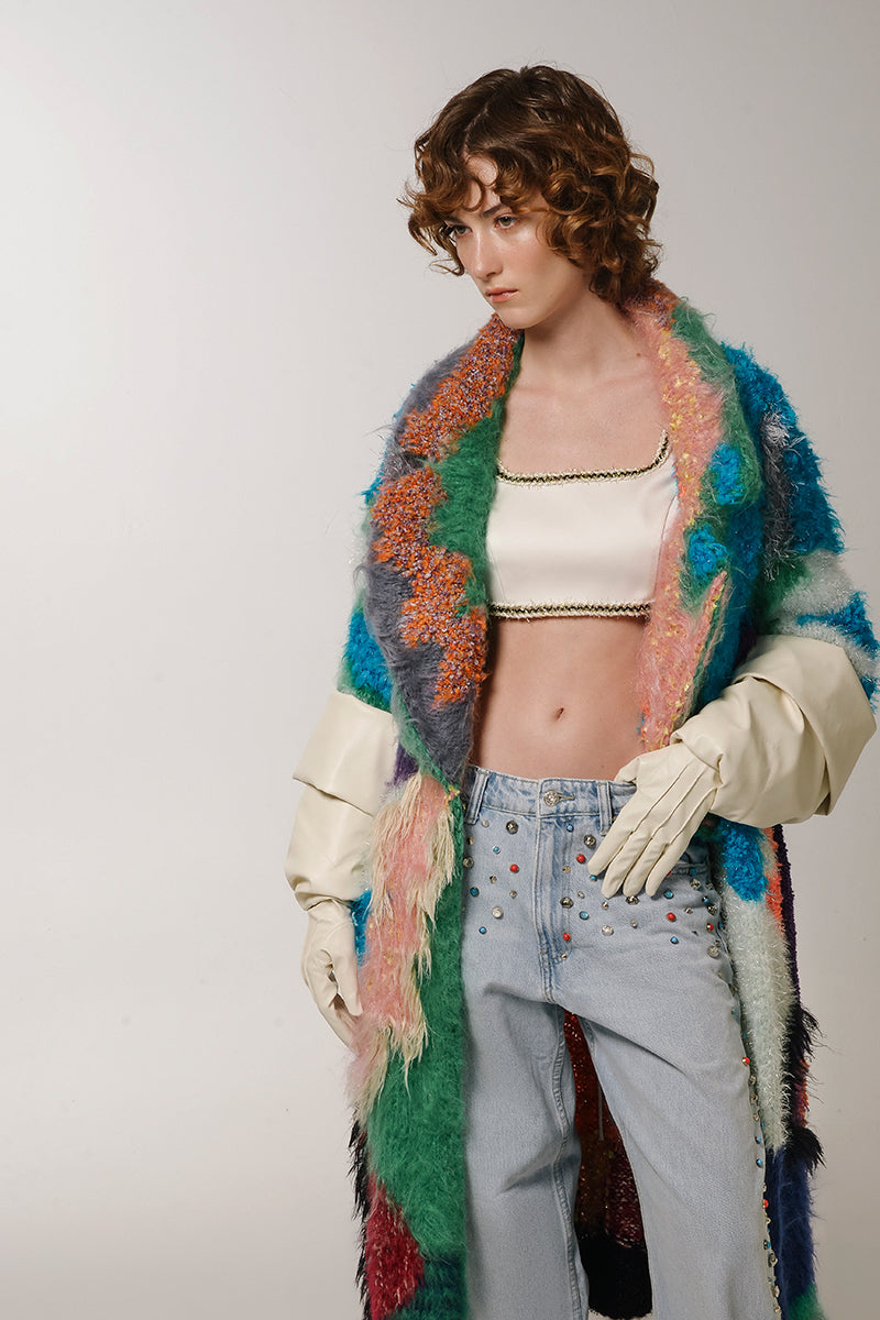 Lalo peach landscape mohair coat displayed on a hanger, featuring soft pastel colors and a textured fabric for a stylish winter look.