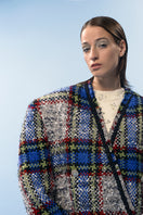 Lalo beige and blue checked wool coat hanging on a rack, showing its classic pattern and tailored fit.