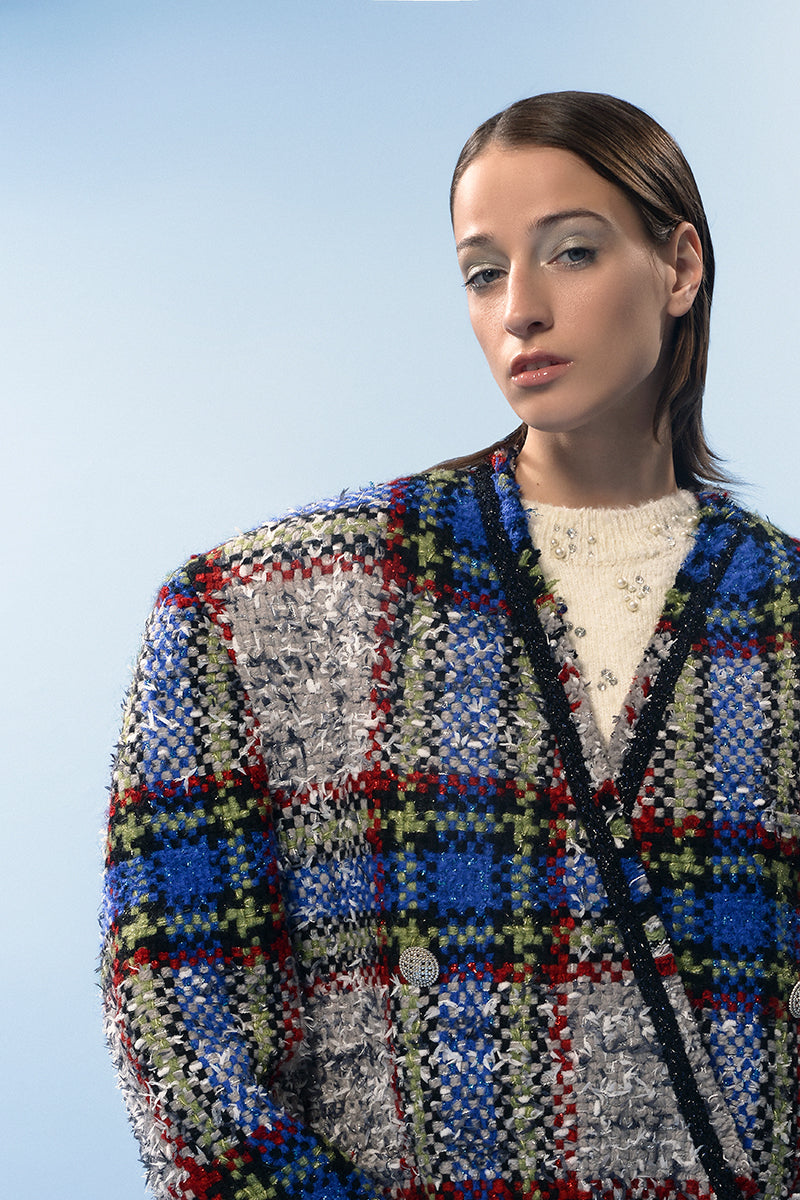 Lalo beige and blue checked wool coat hanging on a rack, showing its classic pattern and tailored fit.