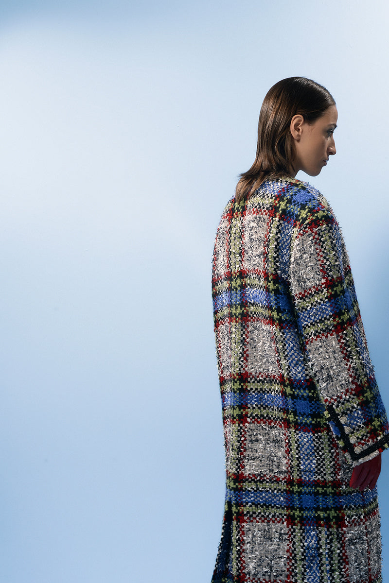 Lalo beige and blue checked wool coat hanging on a rack, showcasing classic pattern and cozy winter style.