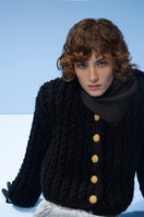 Black cable knit wool cardigan by Lalo, featuring a cozy, textured design, long sleeves, and button closure.