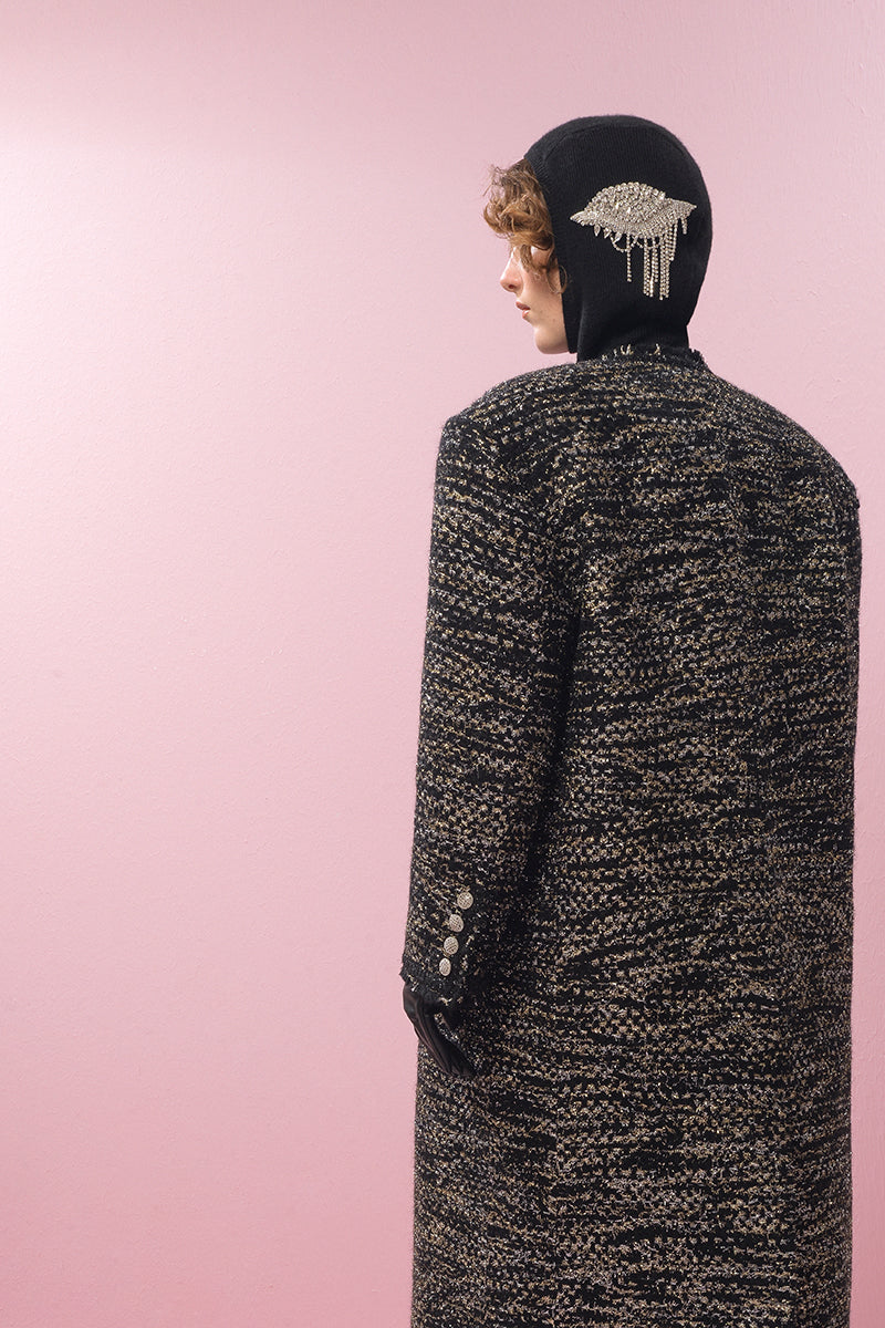Lalo gold and black wool coat displayed on a hanger, showcasing its stylish design and luxurious fabric.