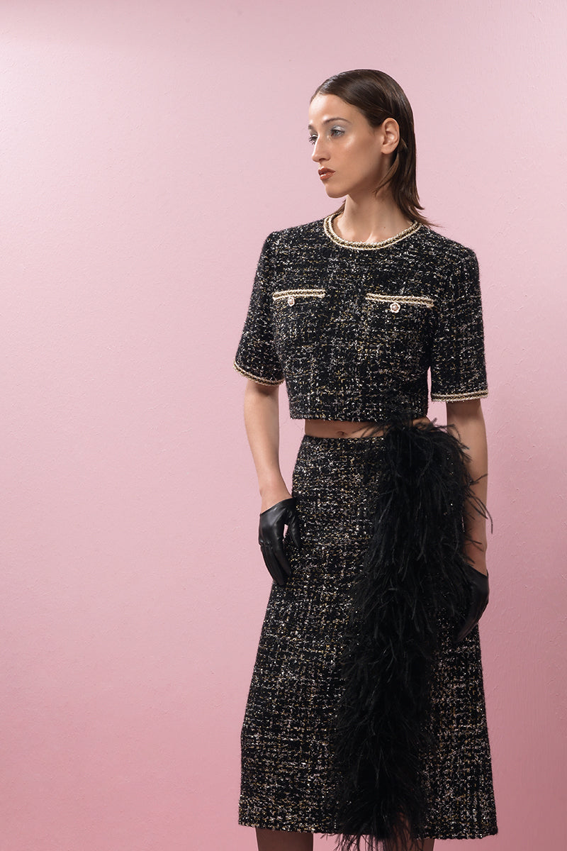 Black wool and feather midi skirt by Lalo, featuring a stylish design with a fitted waistband and flowing feather details.