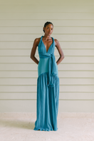 Turquoise maxi dress by Maylé Vásquez with flowing fabric, sleeveless design, and elegant length, perfect for summer or special occasions.