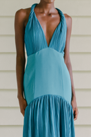 Maylé Vásquez Cayo Turquoise Maxi Dress displayed on a model, featuring a flowing fabric and elegant design perfect for summer wear.