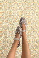 Flabelus Mae grey flats with sleek design, shown on a model's feet, highlighting comfortable slip-on style and soft material.