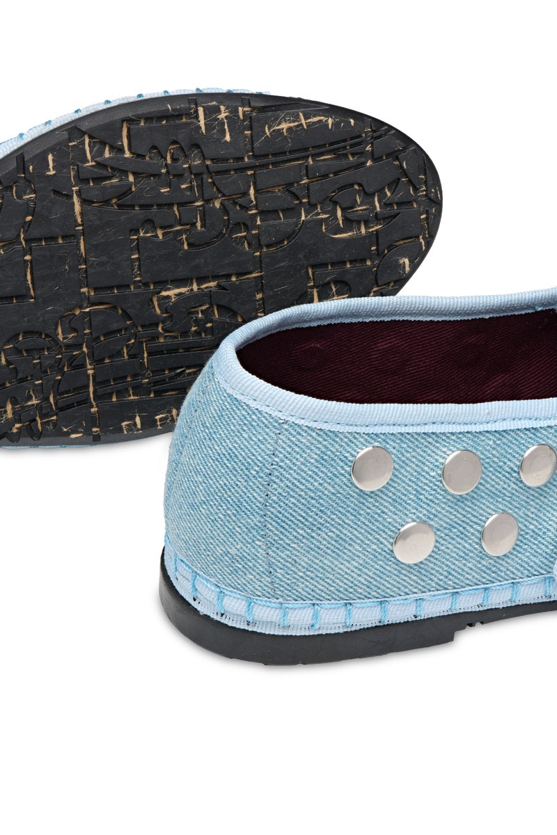 Flabelus Mae silver light denim flats displayed on a white background, showcasing casual, stylish footwear with a silver denim finish.