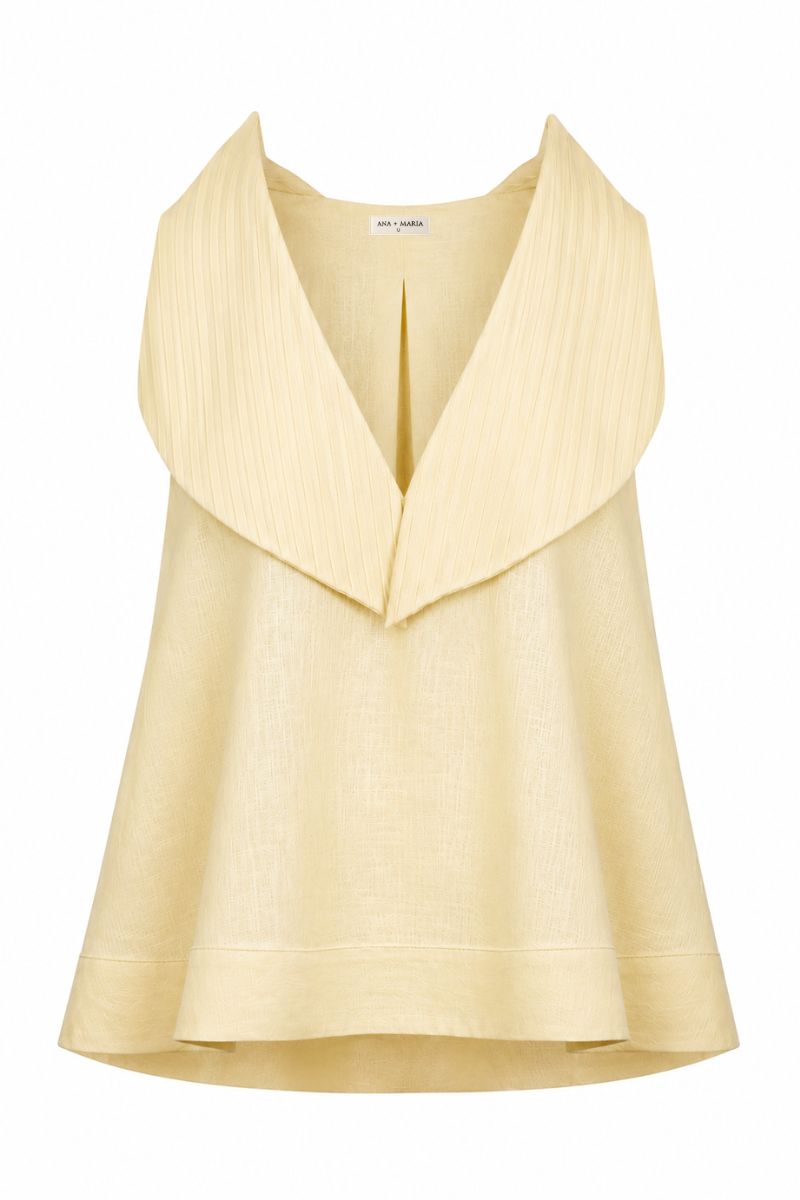 Butter yellow Magnolia blouse by Ana + Maria displayed on a ghost mannequin, showcasing its flowy fabric and stylish design.