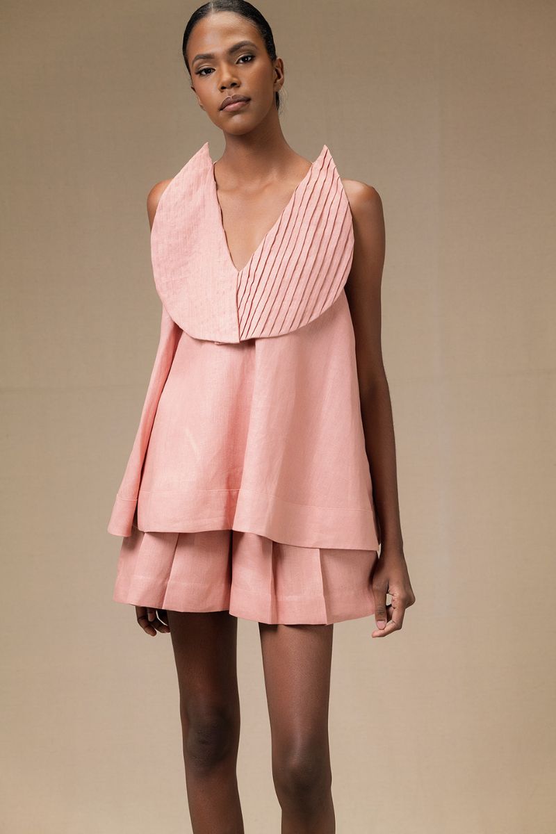 Dark salmon Magnolia blouse by ANA + MARIA, featuring lightweight fabric and stylish design, worn by a model.