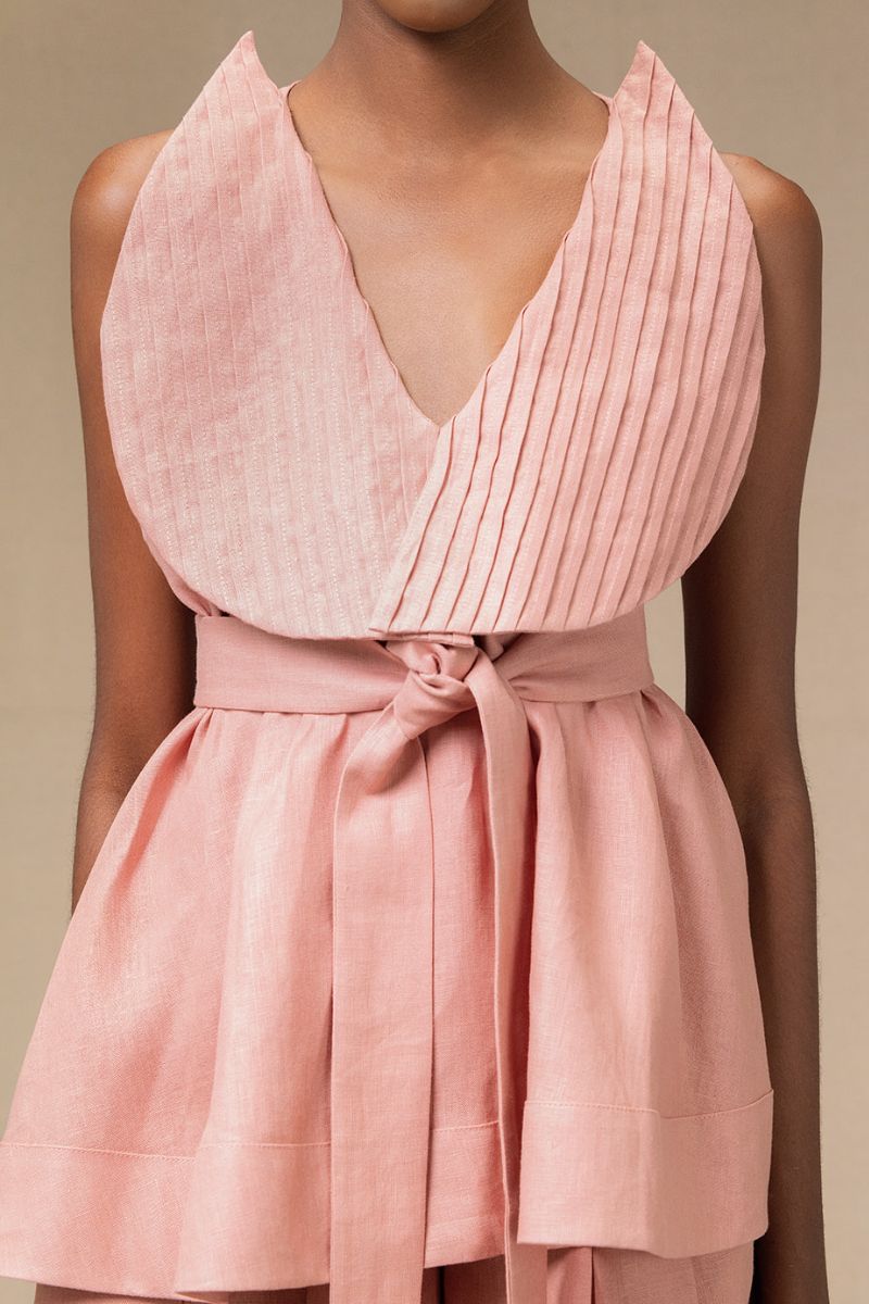Dark salmon Magnolia blouse by ANA + MARIA, featuring lightweight fabric and a relaxed fit, displayed on a hanger.