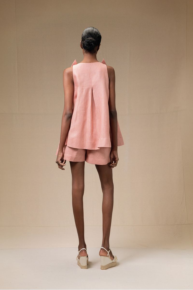 Dark salmon Magnolia blouse by ANA + MARIA, shown in a stylish tops photo with a relaxed fit and flowing fabric.