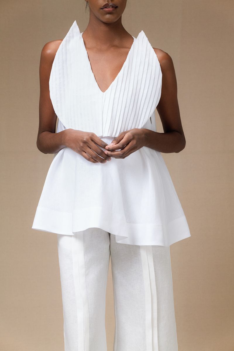 White Magnolia blouse by ANA + MARIA, featuring a lightweight fabric and elegant design, worn by a model with natural styling.