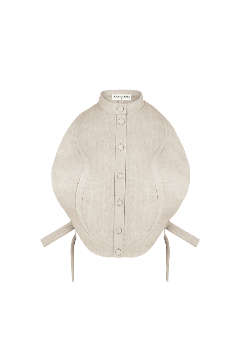 ANA + MARIA Malie Bib in sand, a stylish top with a soft fabric and relaxed fit, shown in a neutral sand color.