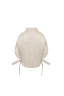 ANA + MARIA Malie Bib in sand, a stylish sleeveless top with a relaxed fit and neutral tone, displayed on a mannequin.