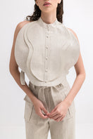 ANA + MARIA Malie bib in sandy beige, stylish and functional tops accessory with adjustable straps and modern design.