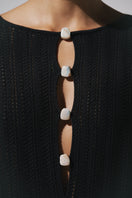 Black Baobab MAMU MAXI dress displayed on a hanger, showcasing its flowing fabric and elegant maxi length.
