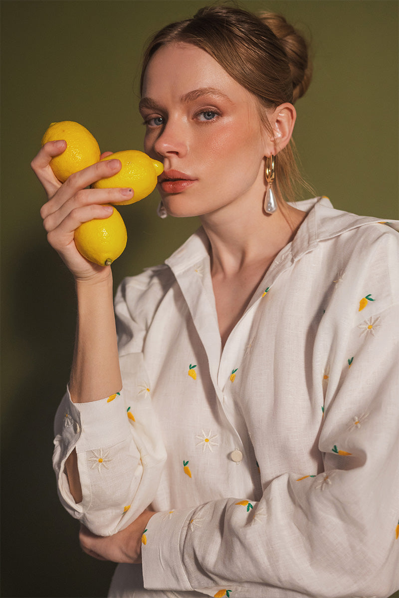 Estefania ivory camomile mango button-down shirt with long sleeves and a classic collar, displayed on a hanger.