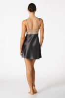 Elegant silk chemise by NK IMODE featuring a sophisticated, sensual design in wet sand color, shown on a model.