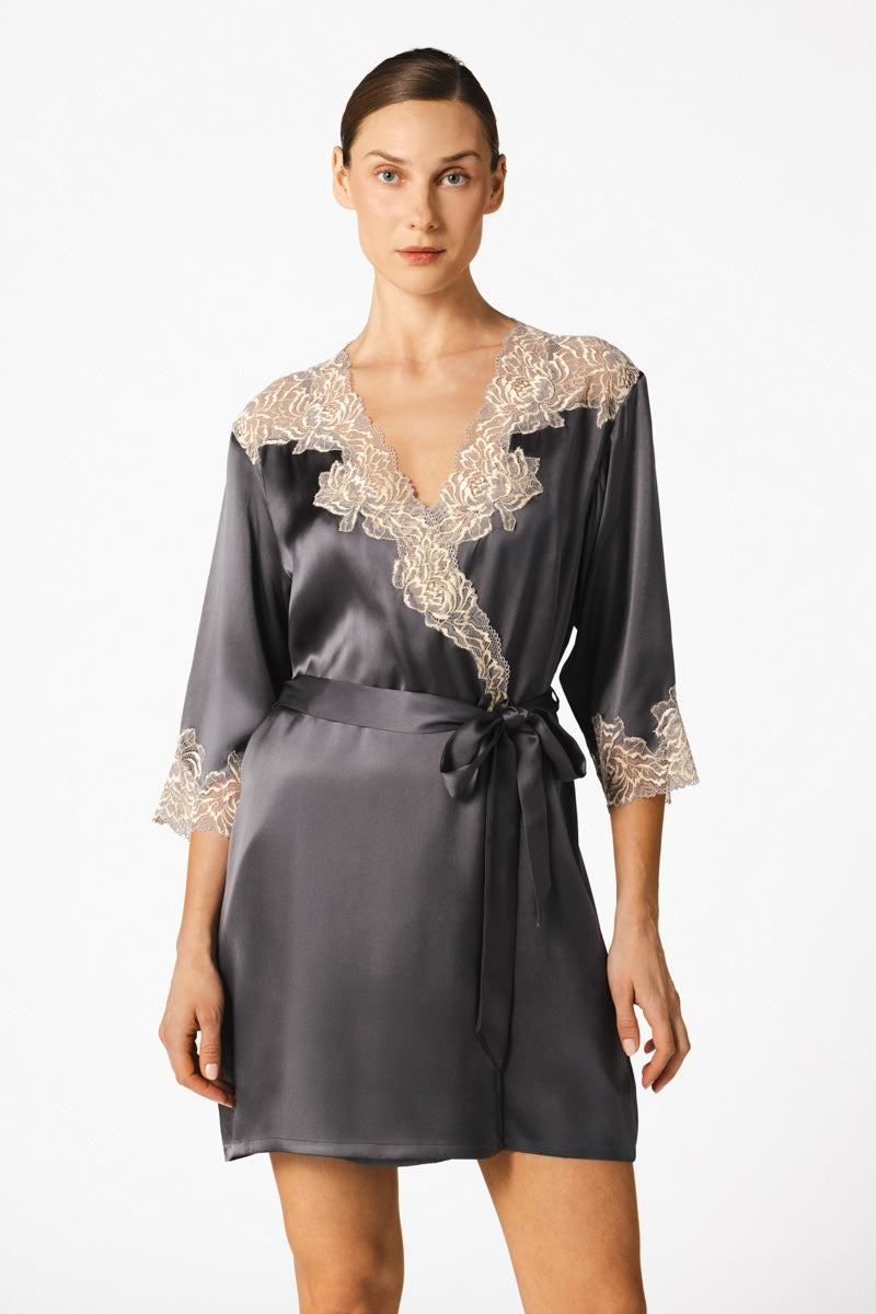 NK IMODE Margaux sophisticated sensual short silk robe in wet sand color, displayed on a hanger with soft fabric details.