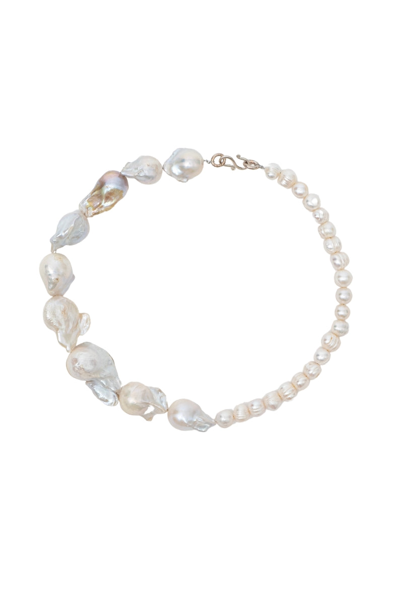Elegant pearl necklace by Oz Objects featuring a classic design, perfect for sophisticated jewelry styling.