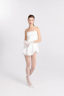 White Marilyn satin mini dress by Nana Jacqueline, close-up of elegant design and smooth fabric details.
