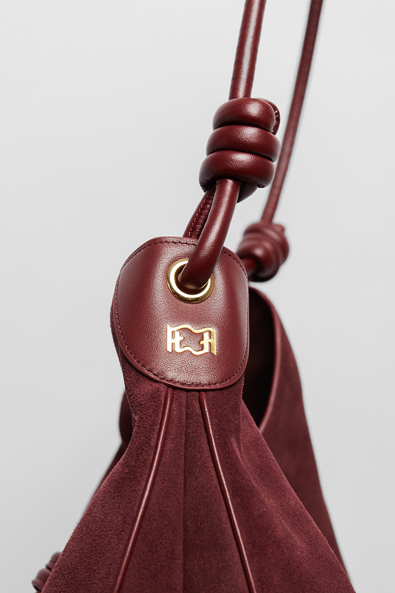 Maroon suede boho shoulder bag from Folklore The Label with a relaxed, stylish design and natural suede texture.