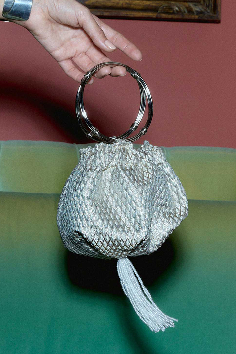 Silver Marquise wristlet with crystal drop detail, designed by Sarah's Bag, featuring a top handle style with elegant embellishments.